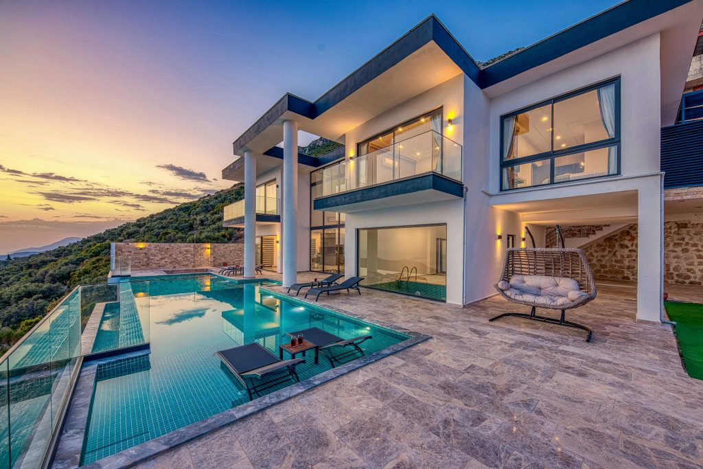 pexels photo 31817157 31817157 Elegant modern villa featuring an infinity pool and scenic hill views during sunset.